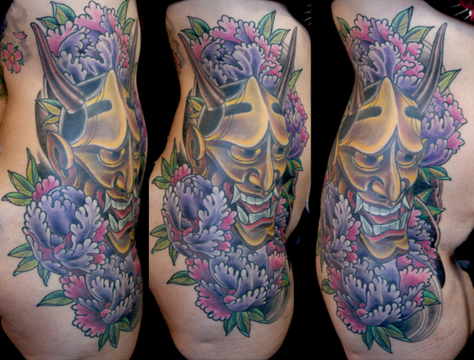 This custom color with black and grey background tattoo was done by Terry 