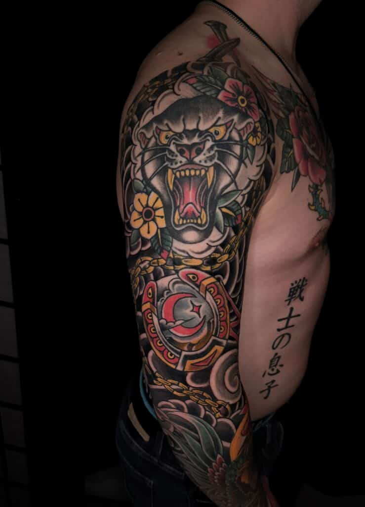 Traditional American sleeve tattoo with tiger and kanji lettering by Chris Cockrill, San Diego tattoo artist