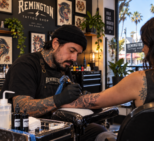Tattoo artist inking a custom design on a client at a North Park San Diego tattoo shop.